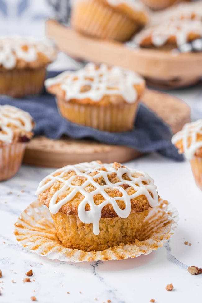 orange muffins with icing on a counter