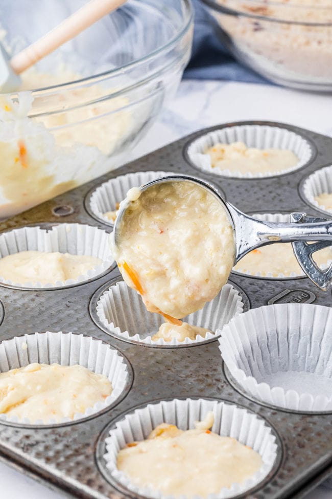 filling muffin pan with batter using an ice cream scoop