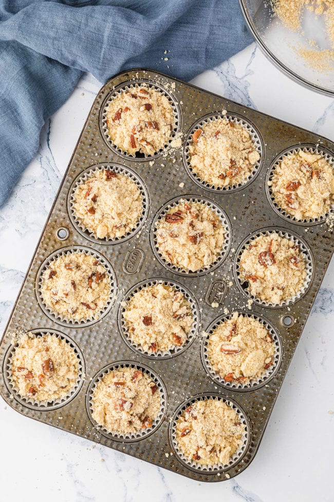 muffin pan filled with batter for orange muffins