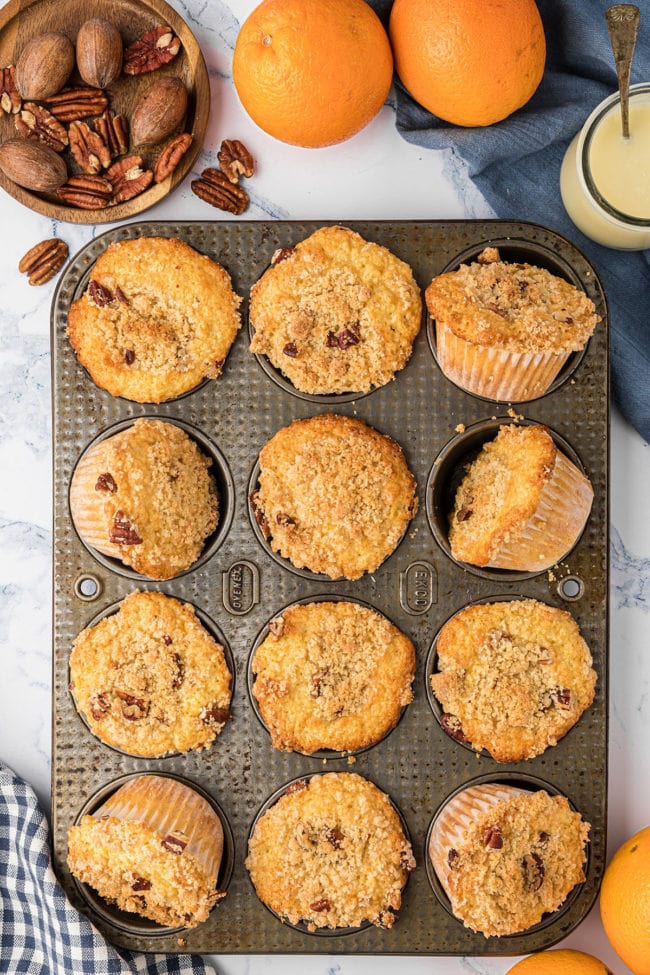 baked orange muffins in a muffin pan