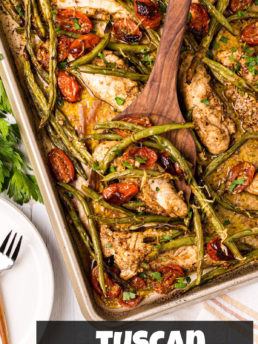chicken tenders, green beans and tomatoes on a large sheet pan