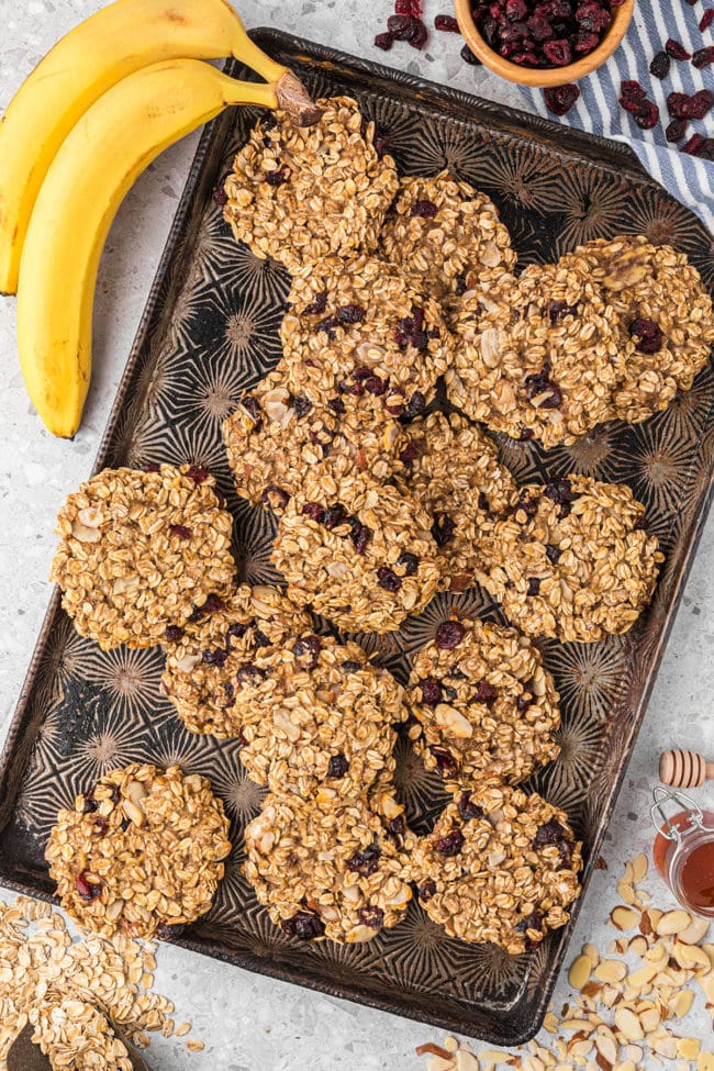 oat breakfast cookies on a sheet pan with bananas on the side