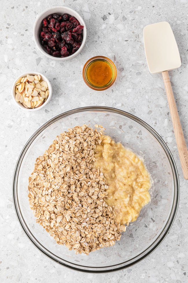 mashed bananas and oats in a glass mixing bowl