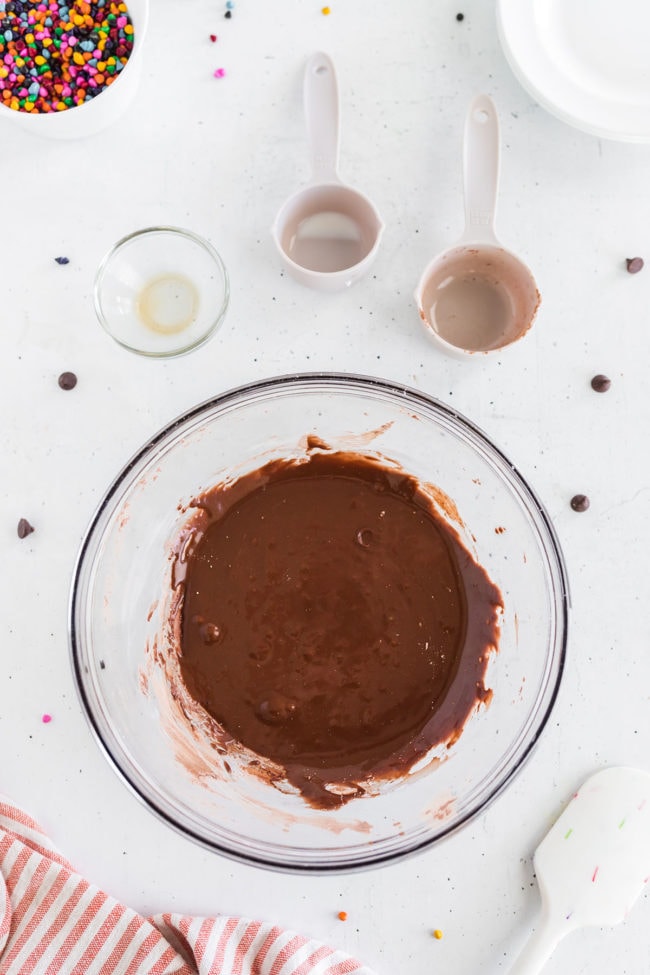 chocolate frosting in a glass mixing bowl