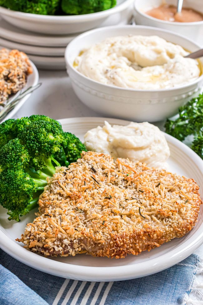 crusted baked pork chops with steamed broccoli and mashed potatoes