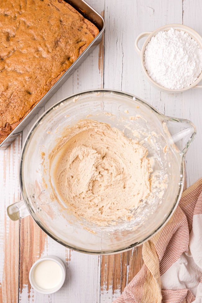 cinnamon frosting in a glass mixing bowl
