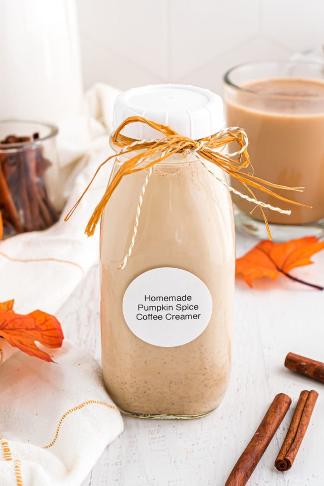 Pumpkin Spice Coffee Creamer in a milk bottle with a lid and bow for gifting