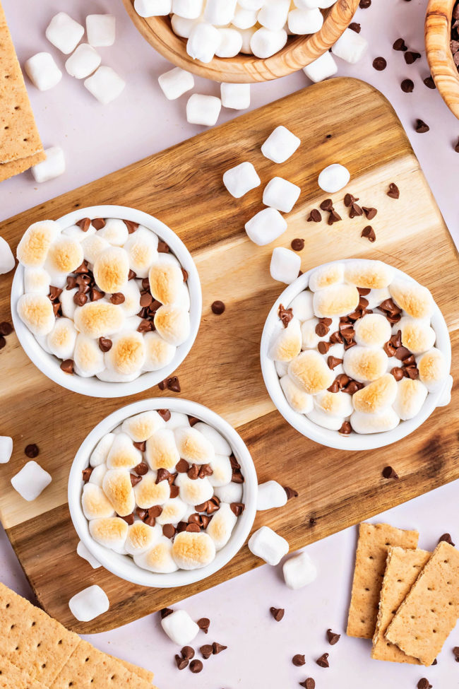 3 bowls of dessert dip with toasted marshmallows