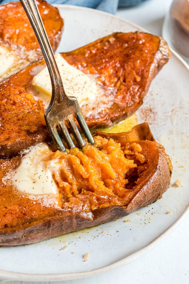 tender baked sweet potatoes with a fork