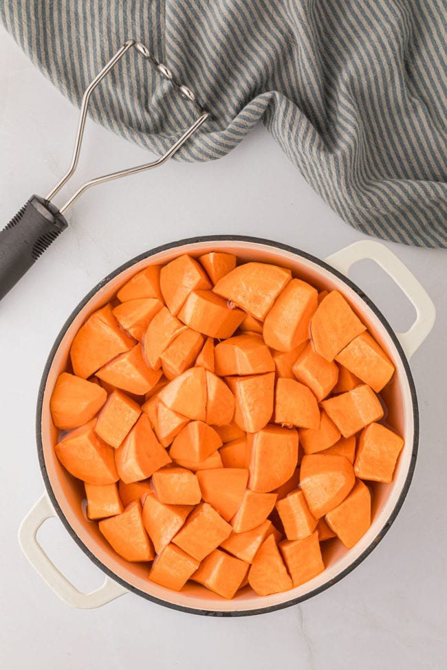 white pot with cubed sweet potatoes