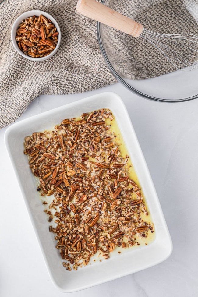 pecan cobbler step 1 pecans and butter in a baking dish