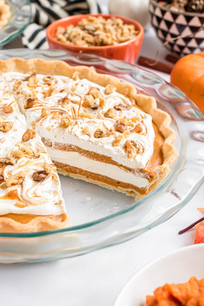 glass pie dish with Pumpkin Chiffon Pie and a slice missing.