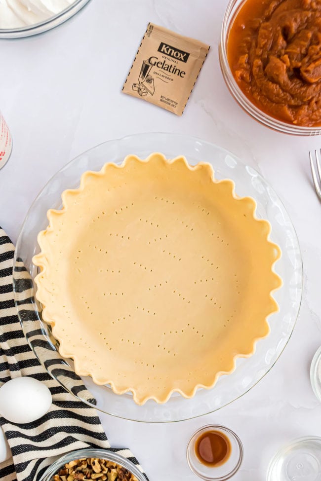 unbaked fluted pie crust in a glass pie dish