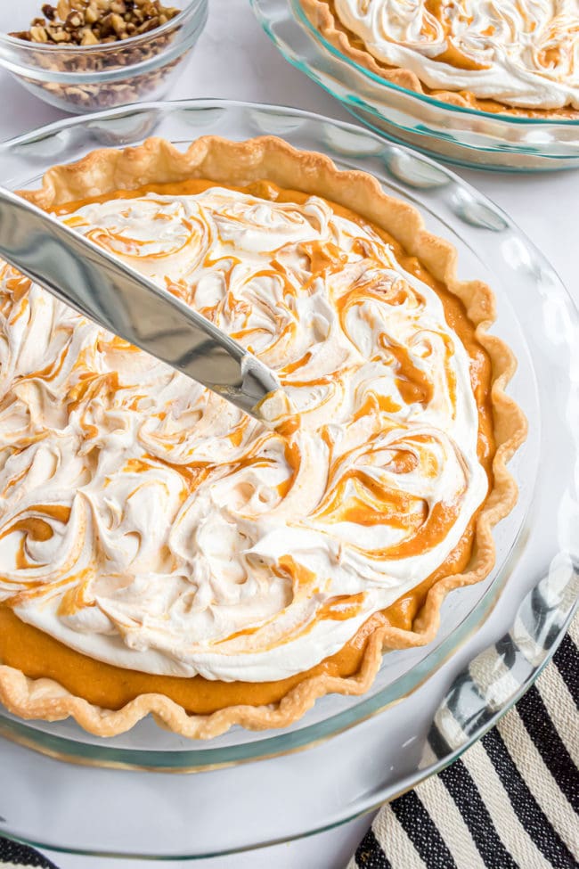 swirling CoolWhip and pumpkin pie filling with a knife for a decorative presentation.