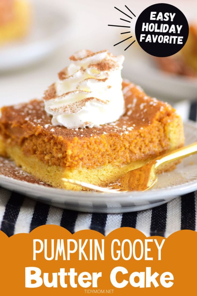 Gooey pumpkin cake with cinnamon whipped cream and a gold fork on a white plate