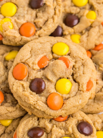 a pile of peanut butter cookies with Reese's Pieces
