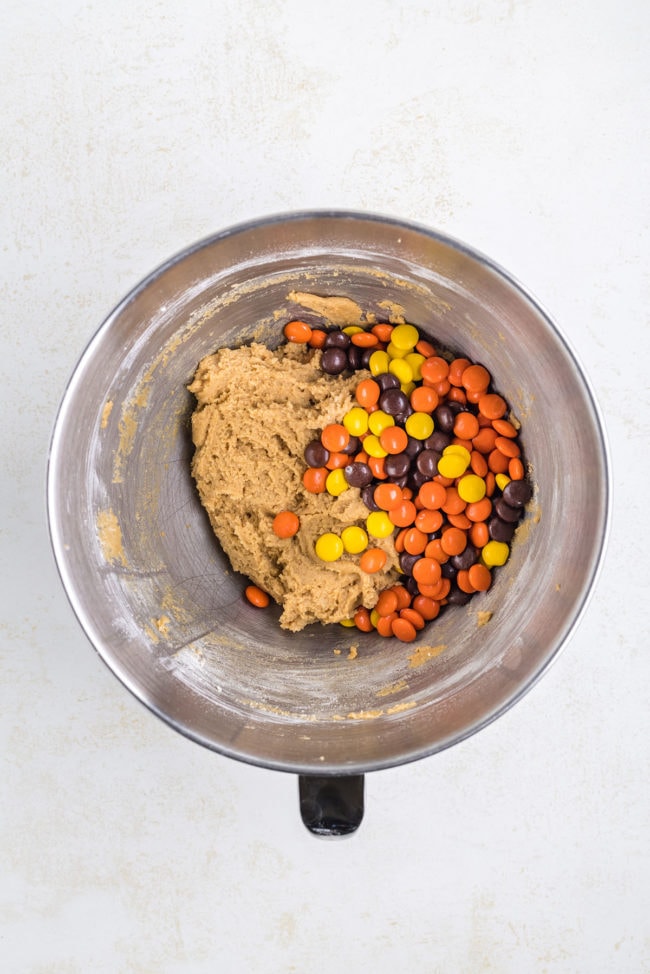 cookie dough with Reese's Pieces in a mixing bowl