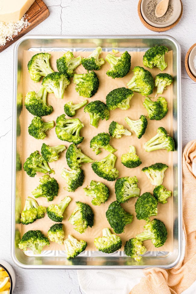 raw broccoli on a baking pan ready for the oven