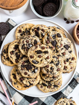 Oreo filled Chocolate chip cookies piled on a white plate