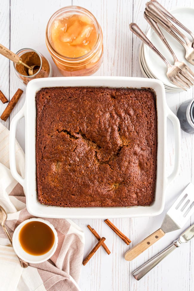 baked apple gingerbread cake in a white square dish