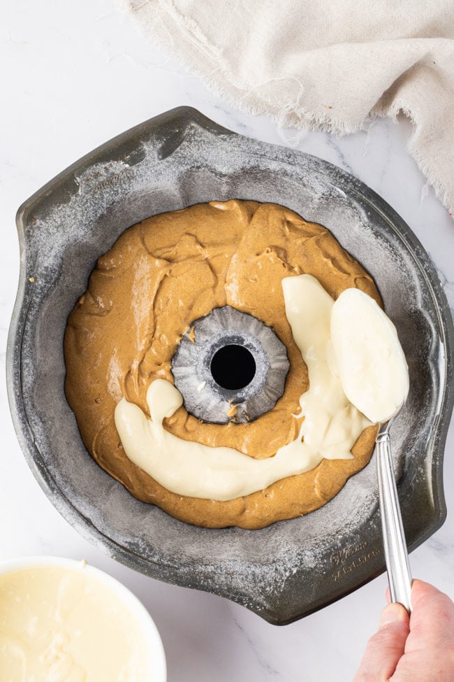 gingerbread cake batter and cheesecake filling in a bundt pan