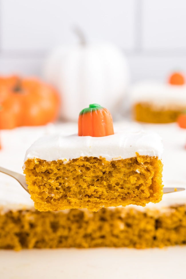 slice of pumpkin cake with a pumpkin candy on a cake server