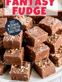 stack of fantasy fudge with nuts on a white plate