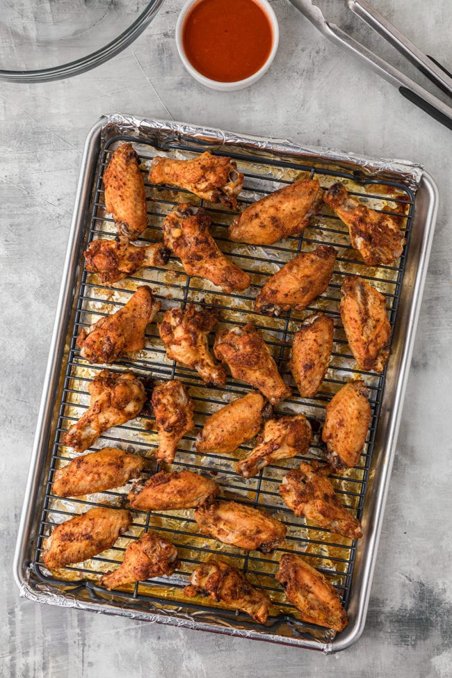 crispy baked chicken wings on a baking pan with a metal baking rack