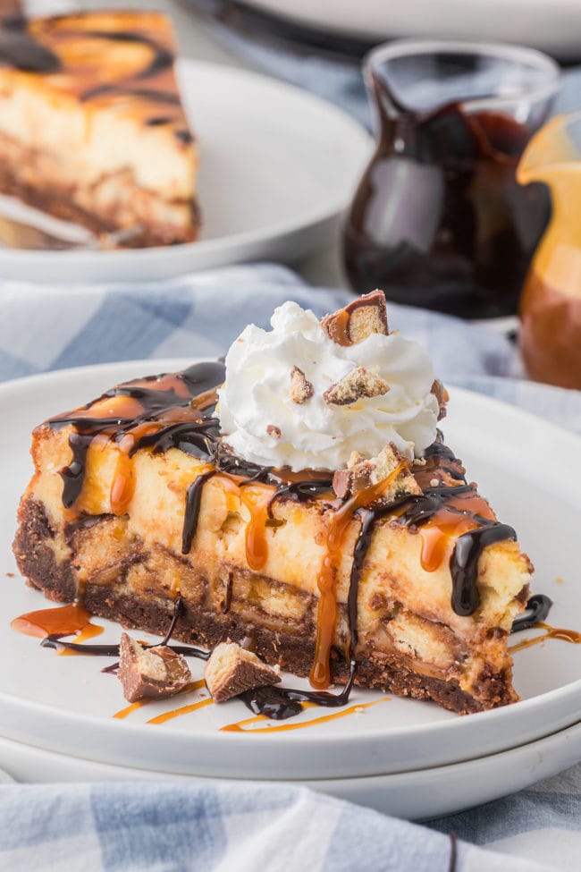 slice of Candy Bar cheesecake with Twix and whipped cream