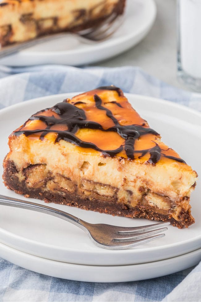 slice of Candy Bar cheesecake on a plate with a fork