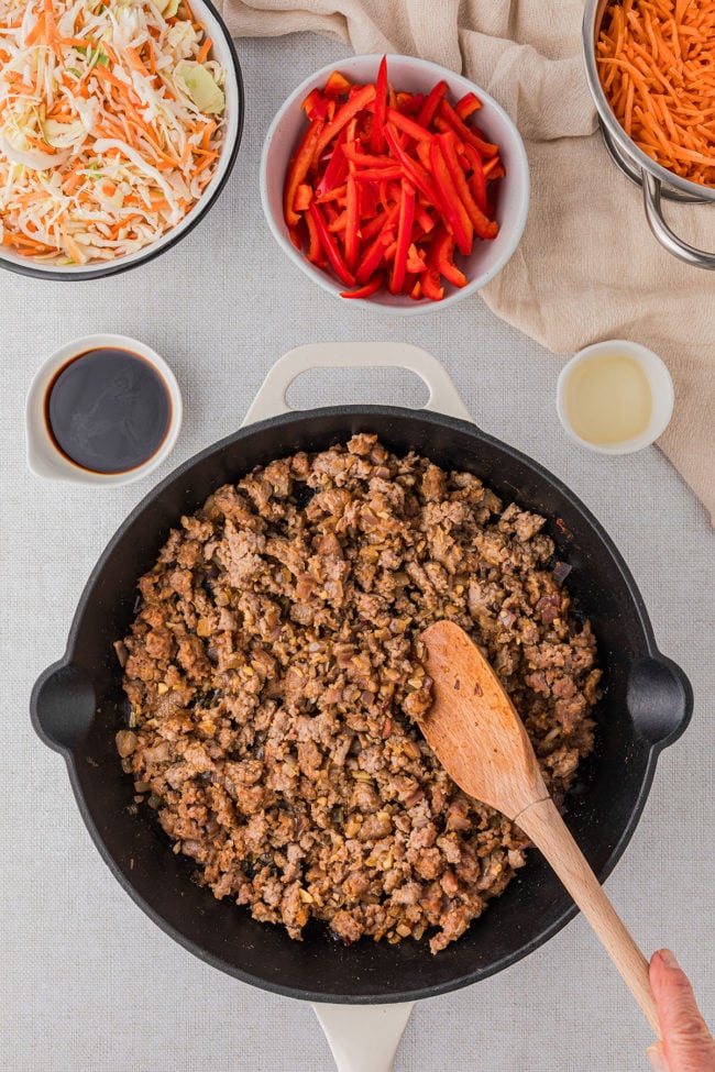 browning ground pork in a cast iron skillet