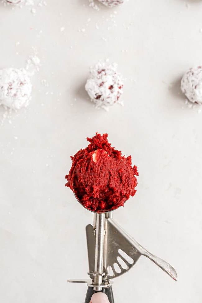 a cookie scoop with red velvet cookie dough