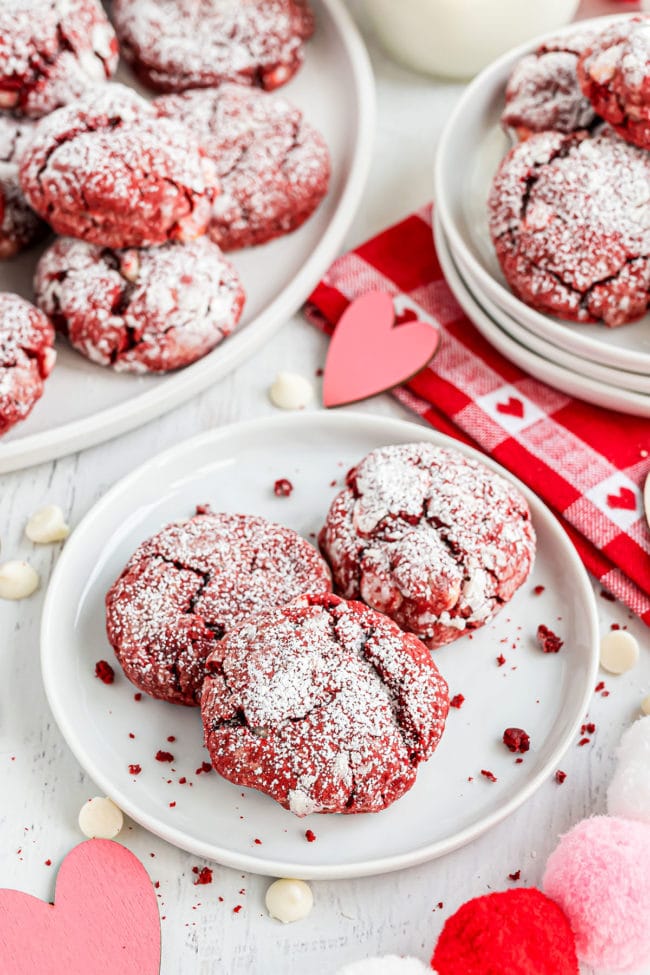 valentine red velvet cookies on white plates with a red and white towel