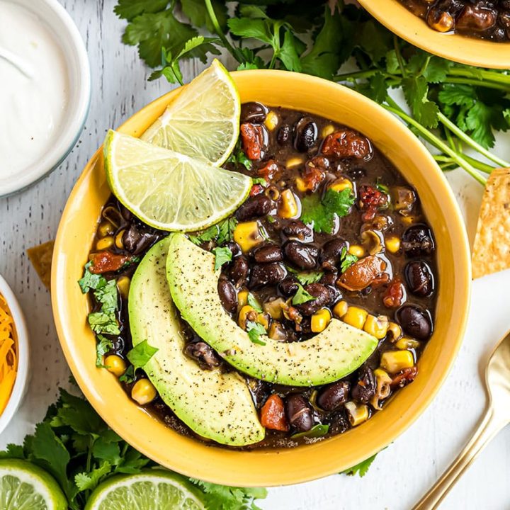 bowl of southwest black bean soup with garnishes