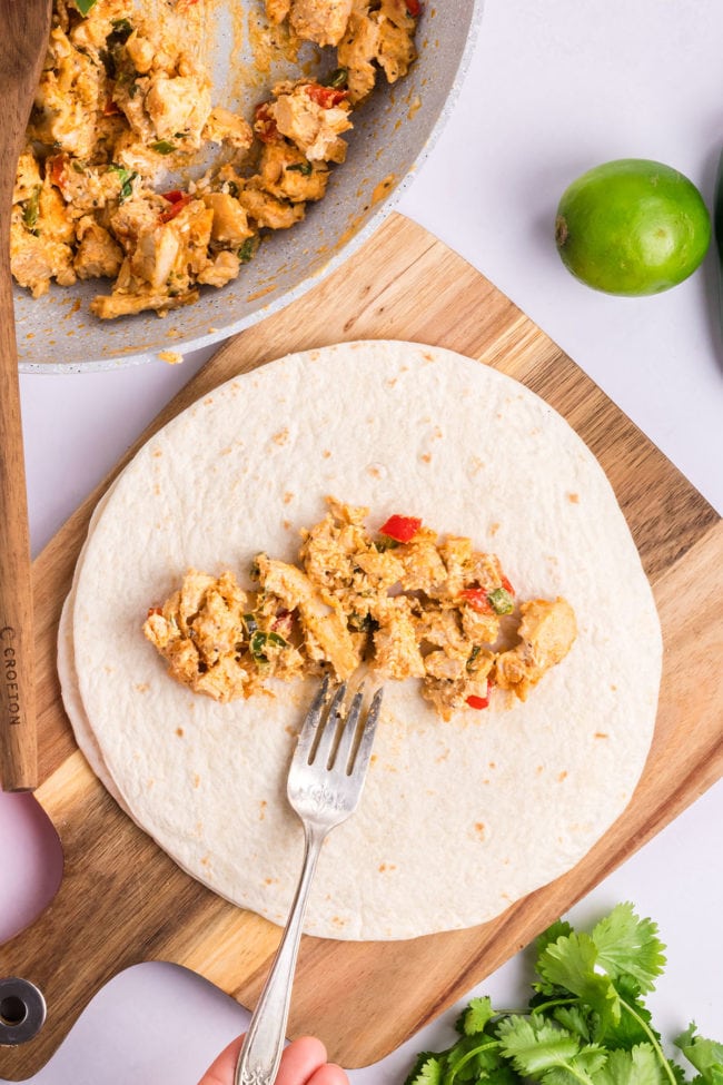 add chicken filling to the center of a tortilla
