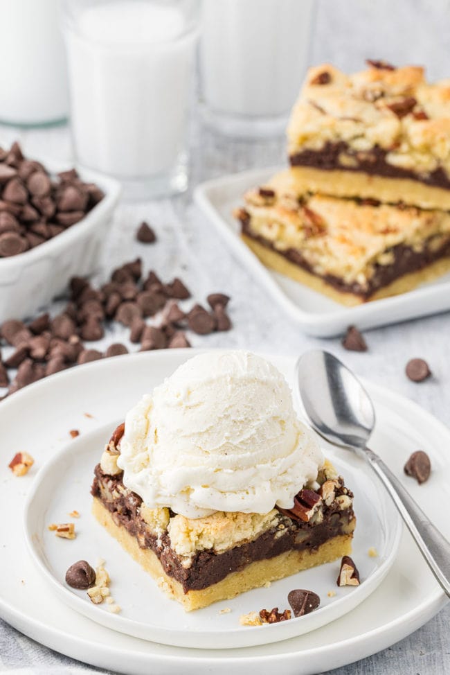 fudge nut cookie bars with a scoop of ice cream on top