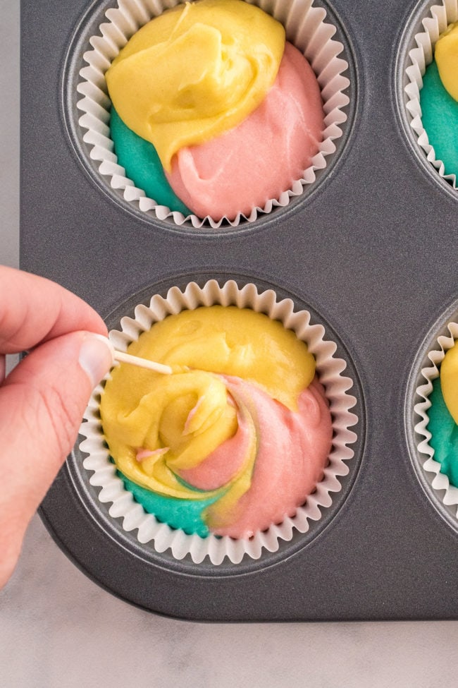 swirling 3 colors of cupcake batter for marble Easter cupcakes