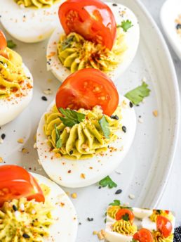 deviled eggs with tomatoes and cilantro