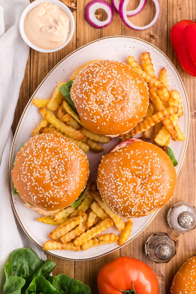 platter of 3 burgers with french fries