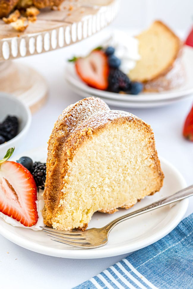 serving of cream cheese pound cake on a plate with fresh berries