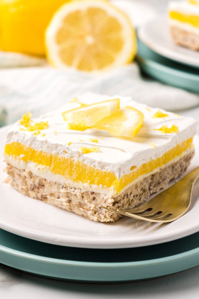 serving of lemon lush dessert with a fork on a plate