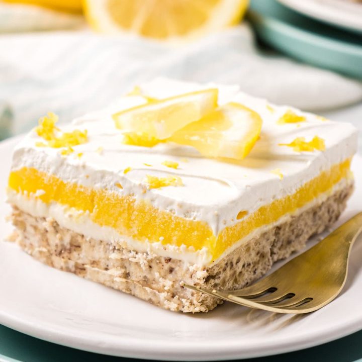 serving of lemon lush dessert with a fork on a plate