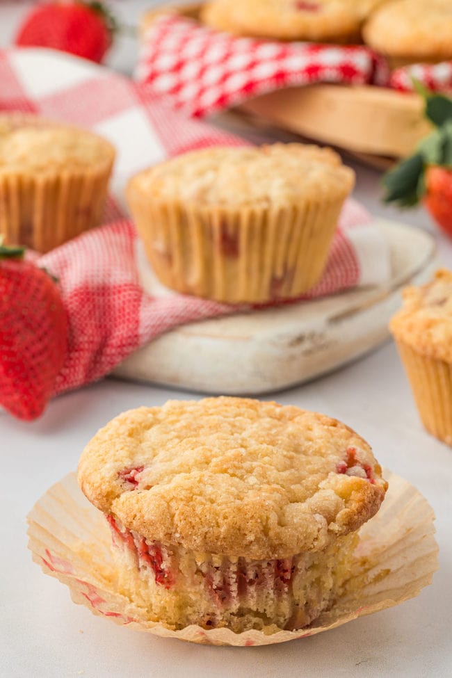 homemade strawberry muffin with the paper liner pulled down