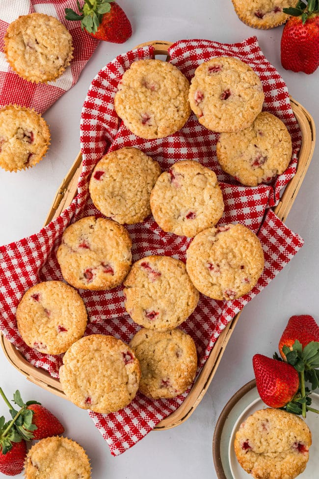 strawberry muffins with a red checked napkin in a basket