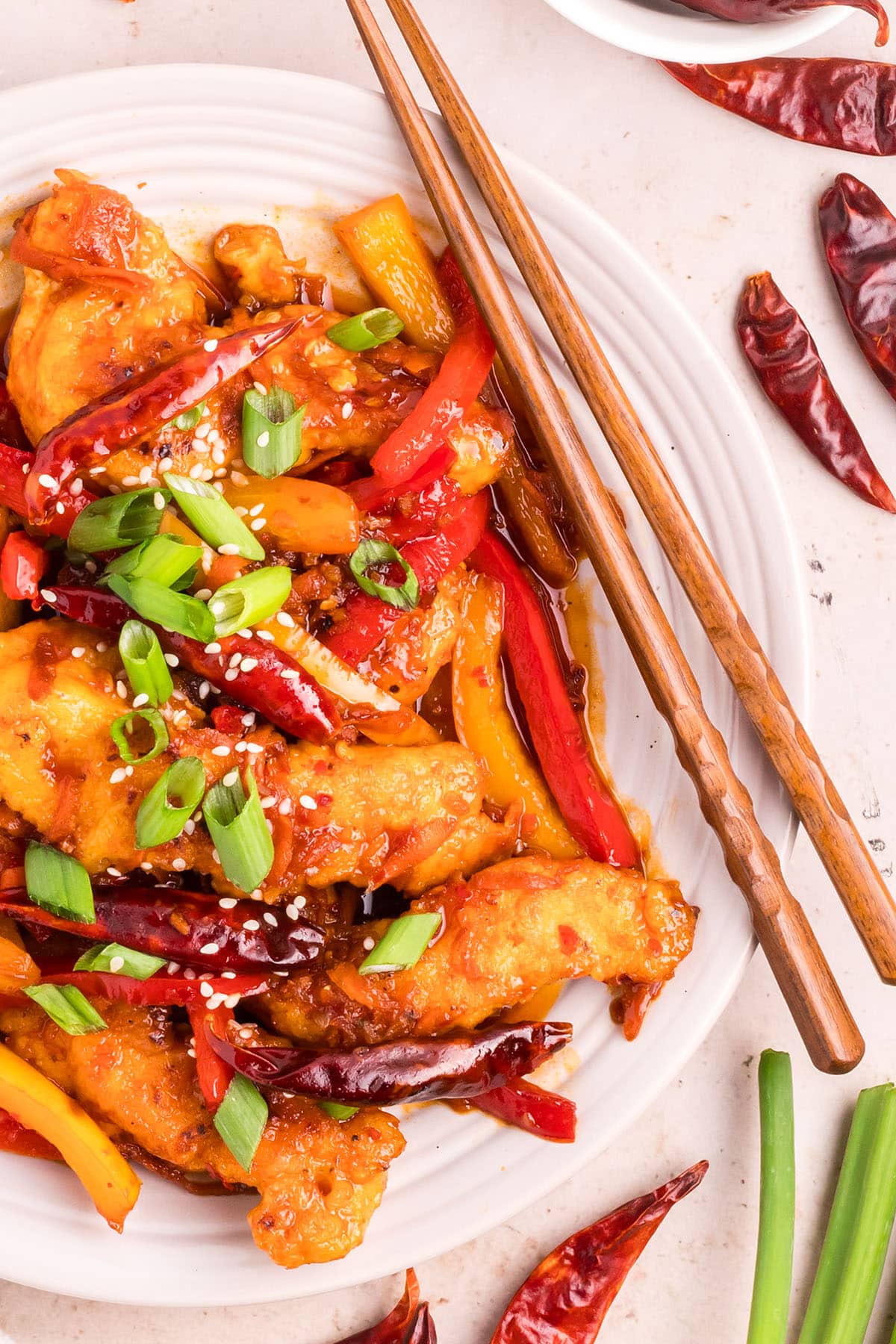 hot and spicy chicken with colorful veggies with chopsticks