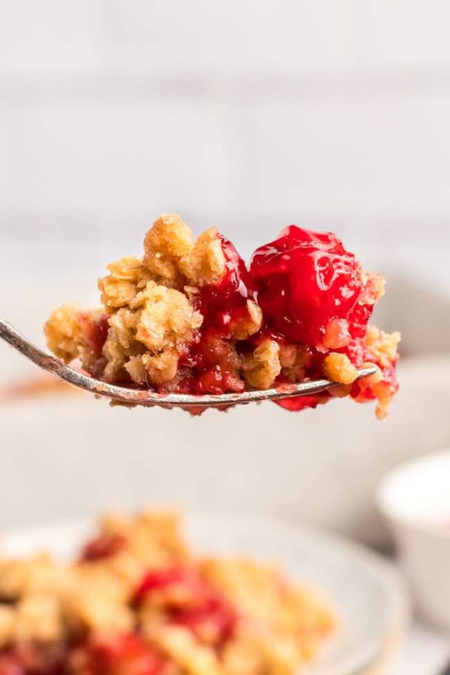 a bite of cherry crumble on a fork