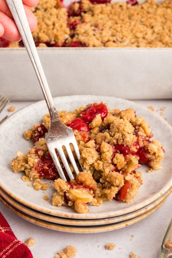 cherry crumble on a plate with a fork