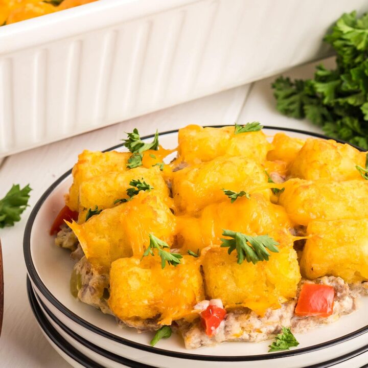 cheesy tater tot casserole with ground beef on a white plate