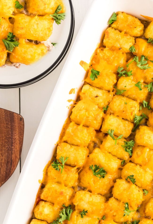 cheesy tater tot casserole in a white baking dish