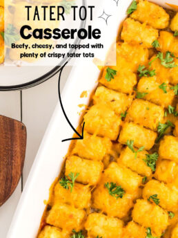 crispy cheesy tater tot casserole in a white baking dish